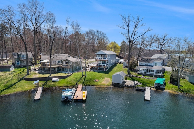 dock area featuring a yard, a water view, and a residential view