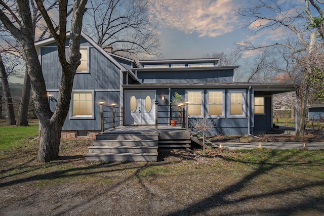 rear view of property featuring crawl space