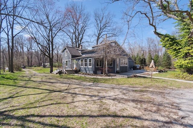 view of side of home with board and batten siding and a yard