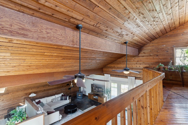 hall with wood walls, wood-type flooring, lofted ceiling, and wood ceiling