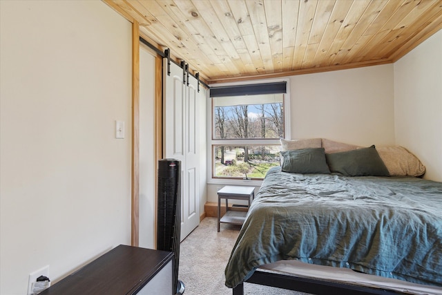 bedroom with a barn door, ornamental molding, carpet, and wood ceiling