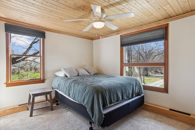 bedroom featuring visible vents, ceiling fan, crown molding, and wood ceiling