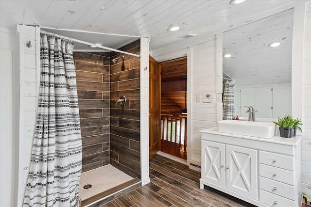 full bathroom featuring a tile shower, recessed lighting, wood finished floors, and wood ceiling