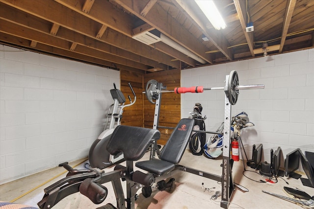 exercise room featuring concrete block wall