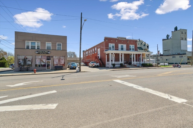 view of street featuring curbs, sidewalks, and street lights