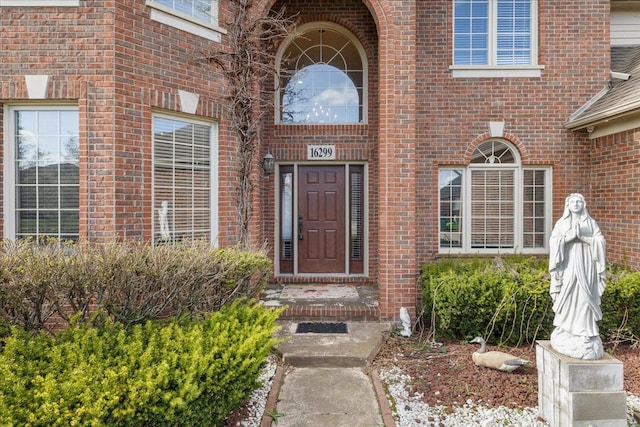 property entrance featuring brick siding