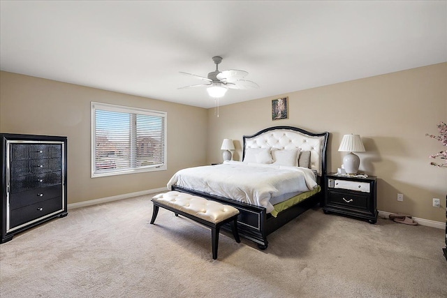 bedroom with ceiling fan, light carpet, and baseboards