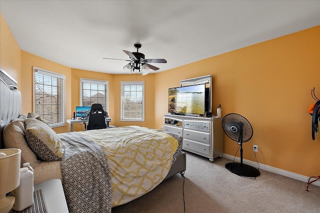 bedroom featuring ceiling fan, baseboards, and light carpet