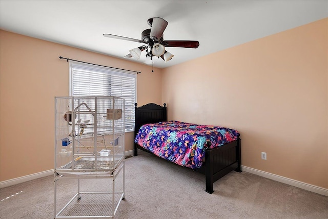 bedroom with ceiling fan, baseboards, and carpet flooring