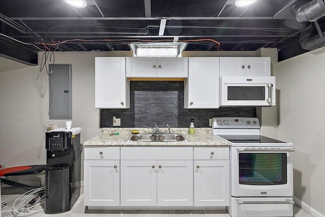 kitchen with white cabinets, baseboards, a sink, and white appliances