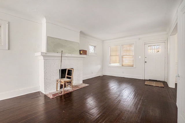 unfurnished living room with hardwood / wood-style floors, baseboards, and a fireplace
