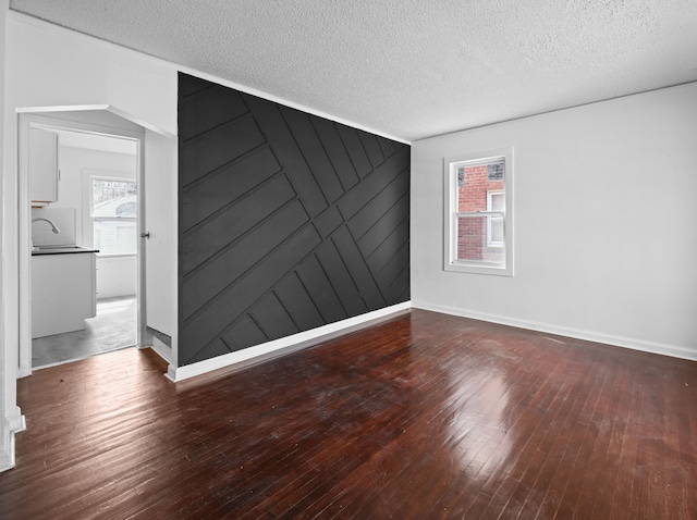 12816 Payton St, Detroit, MI 48224 - spare room featuring hardwood / wood-style floors, baseboards, and a textured ceiling