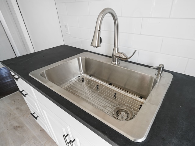 12816 Payton St, Detroit, MI 48224 - interior details with white cabinets, light wood finished floors, and a sink