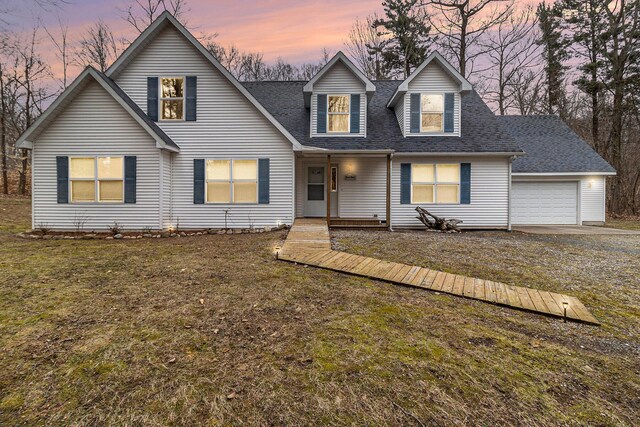 10412 W Woodrow Rd, Shelby, MI 49455 - view of front of home with a garage, a front lawn, a shingled roof, and dirt driveway