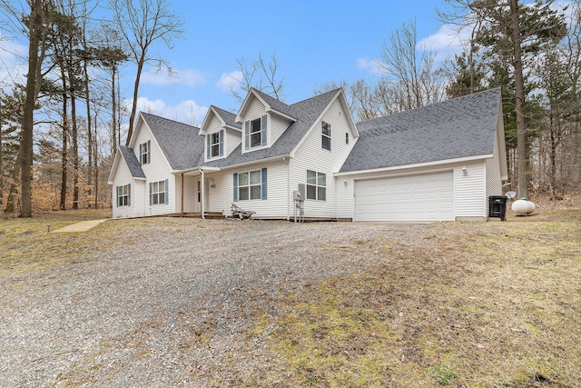 10412 W Woodrow Rd, Shelby, MI 49455 - cape cod home featuring roof with shingles, an attached garage, and gravel driveway