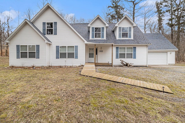 10412 W Woodrow Rd, Shelby, MI 49455 - new england style home featuring driveway, a shingled roof, a garage, and a front lawn
