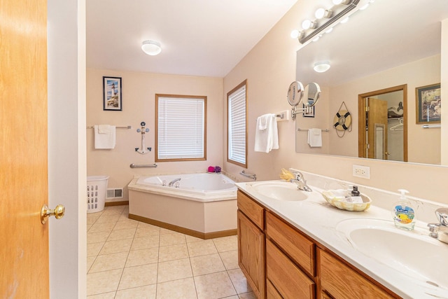 10412 W Woodrow Rd, Shelby, MI 49455 - bathroom with a garden tub, a sink, tile patterned flooring, and visible vents