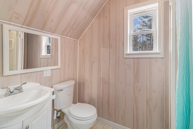 10412 W Woodrow Rd, Shelby, MI 49455 - bathroom featuring wood walls, toilet, vanity, and vaulted ceiling