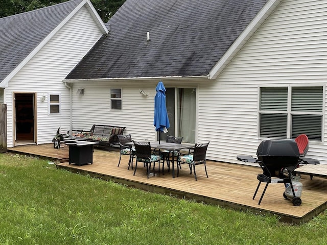 10412 W Woodrow Rd, Shelby, MI 49455 - back of property with outdoor dining space, a yard, a deck, and a shingled roof