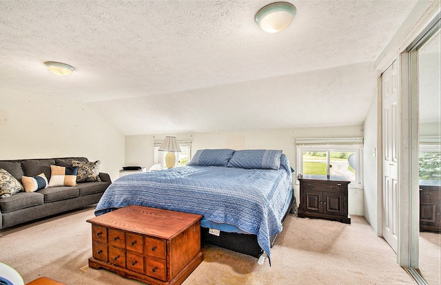 carpeted bedroom with access to outside, a textured ceiling, and vaulted ceiling
