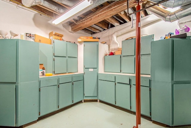 unfinished below grade area featuring freestanding refrigerator