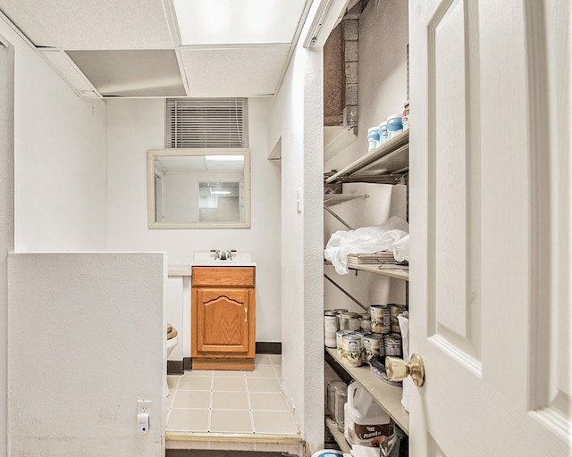 bathroom with vanity and a drop ceiling
