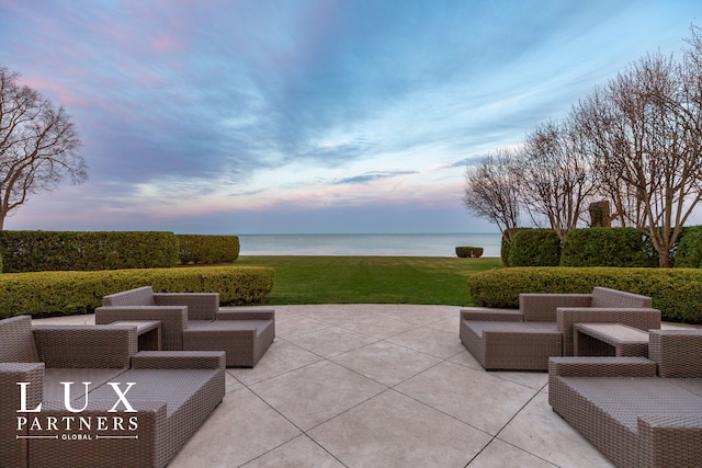 view of patio with an outdoor living space and a water view