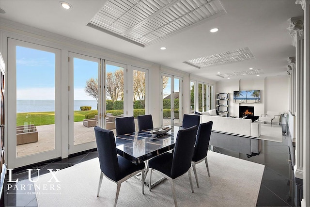 sunroom with a water view and french doors