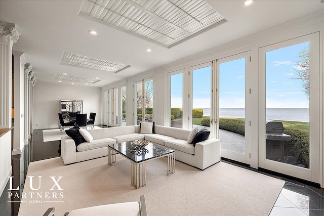 sunroom / solarium with french doors and a water view