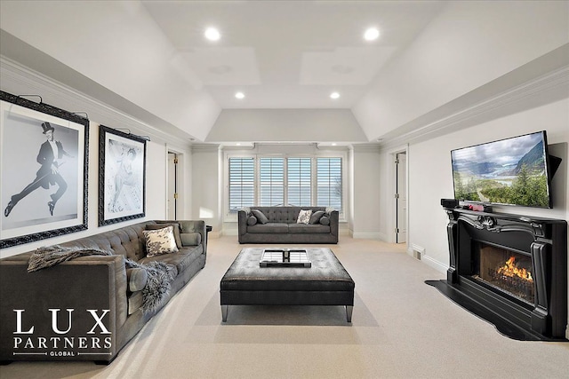 living room featuring a lit fireplace, recessed lighting, carpet floors, visible vents, and lofted ceiling