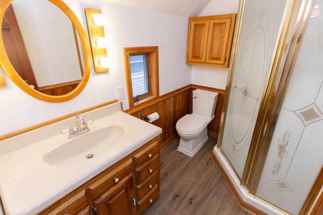 full bath featuring vanity, a wainscoted wall, toilet, wood finished floors, and a stall shower