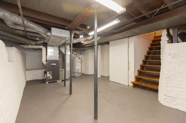 below grade area featuring heating unit, stairs, and water heater