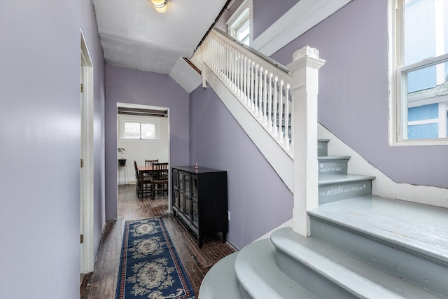 stairs featuring wood finished floors