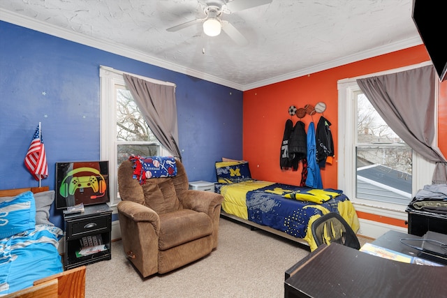 carpeted bedroom with ornamental molding and a ceiling fan