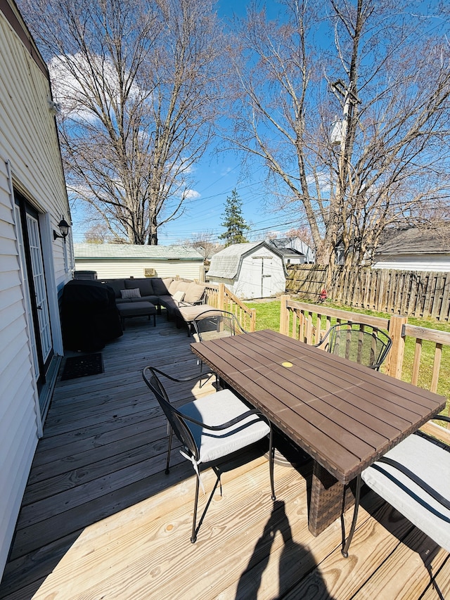 wooden deck featuring outdoor dining space and fence