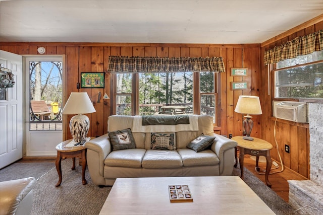 living area featuring wood walls, cooling unit, and wood finished floors