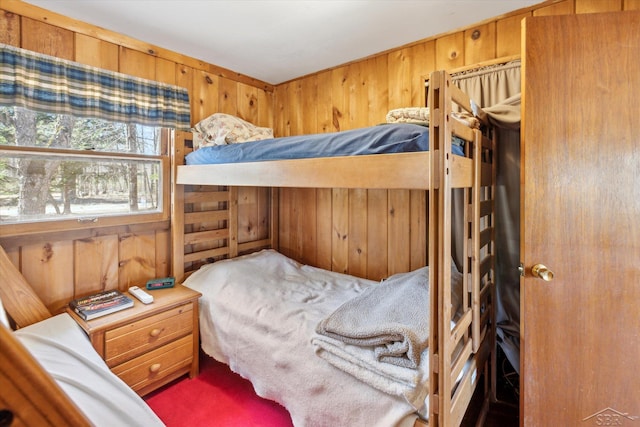 bedroom featuring wood walls