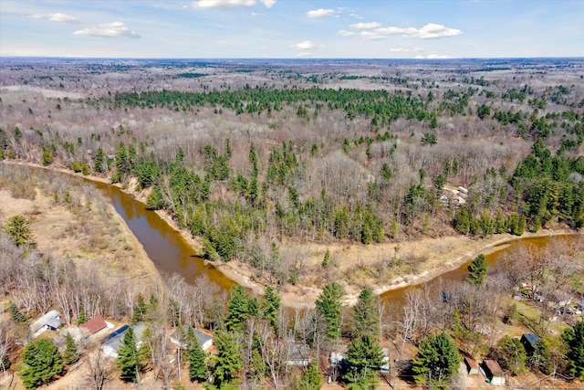 aerial view with a wooded view and a water view