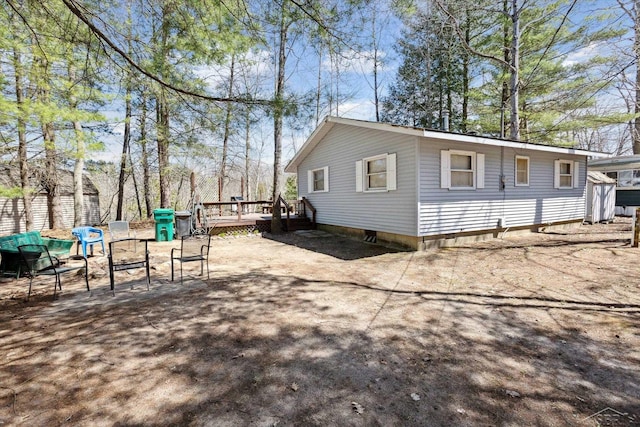 view of home's exterior with a wooden deck