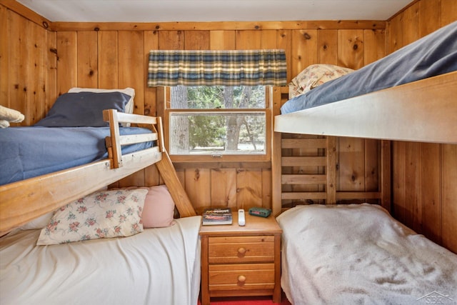 bedroom featuring wood walls