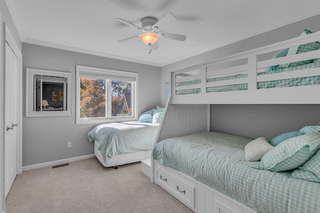 bedroom featuring light colored carpet, baseboards, ornamental molding, and visible vents