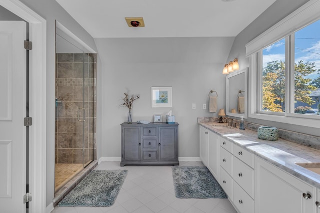 bathroom with tile patterned flooring, baseboards, a shower stall, and vanity
