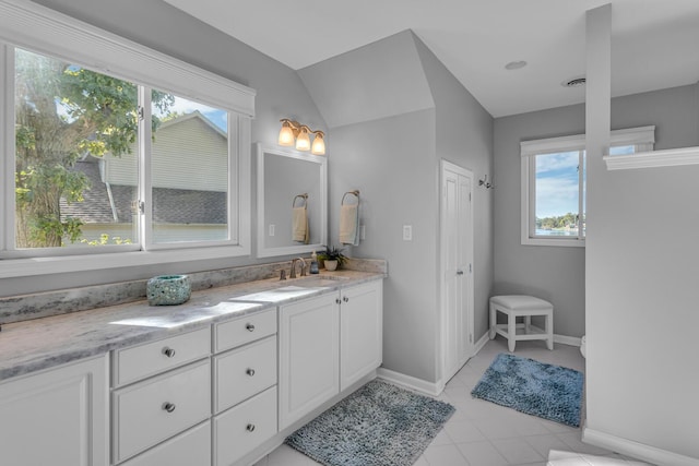 bathroom featuring visible vents, baseboards, vanity, and tile patterned floors