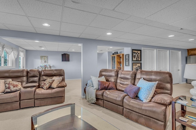 living room with a paneled ceiling, baseboards, and recessed lighting