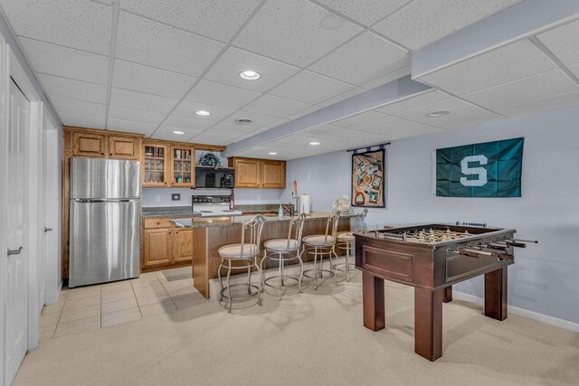 recreation room with light carpet, recessed lighting, a drop ceiling, and baseboards