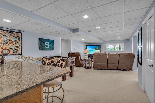 living room featuring recessed lighting, a paneled ceiling, and light carpet