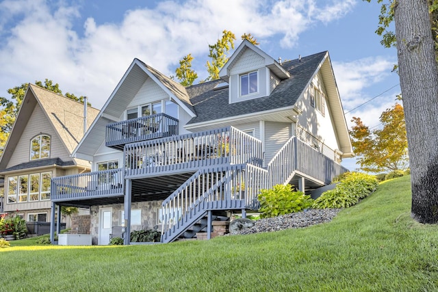 back of house featuring a yard, a wooden deck, stairs, and roof with shingles