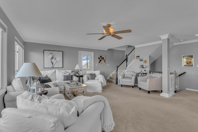carpeted living area featuring ceiling fan, baseboards, and ornamental molding