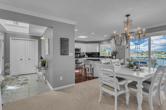 dining room with a chandelier, light carpet, ornamental molding, and recessed lighting