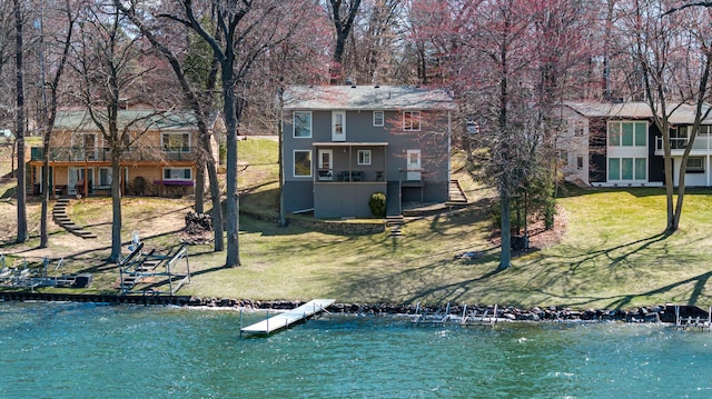 11672 Bradley Dr, Jerome, MI 49249 - rear view of house with a yard, stairway, and a water view